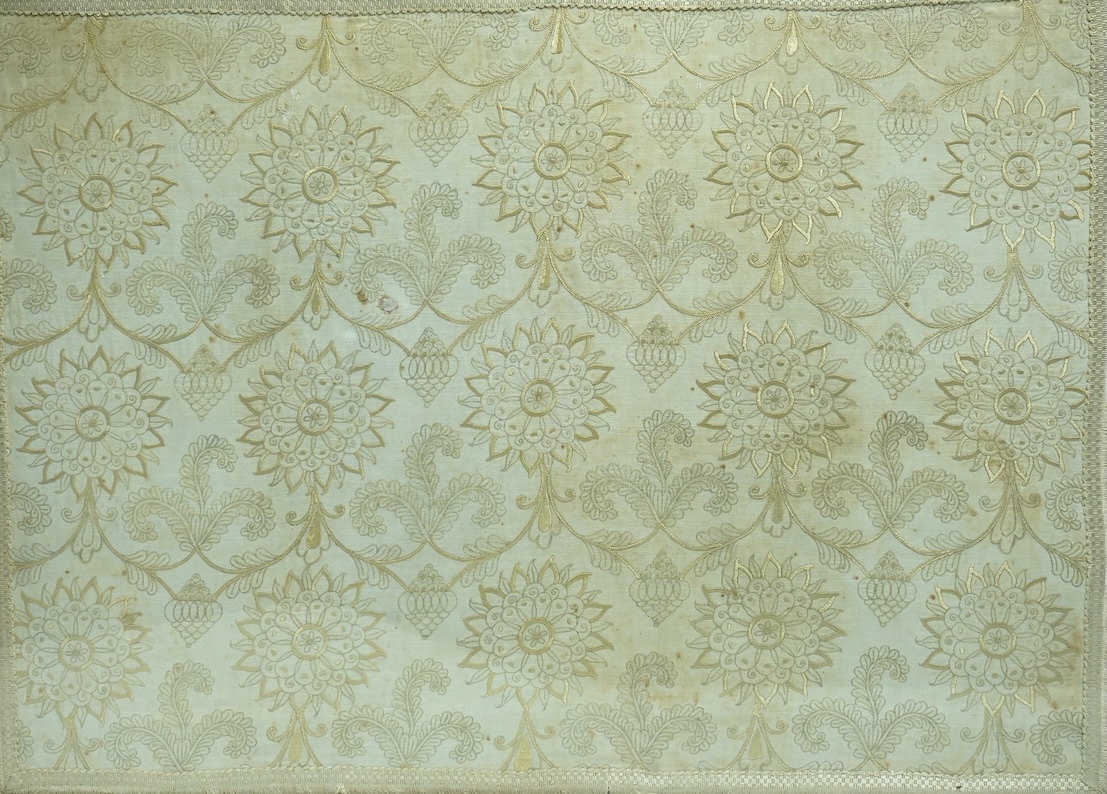 A 17th century fine gold silk thread embroidery, worked on a hand spun linen ground, depicting scrolling three feather motifs, rose shaped flower heads and Persian inspired Botha. Framed., 56cm high x 78cm wide. (Provena